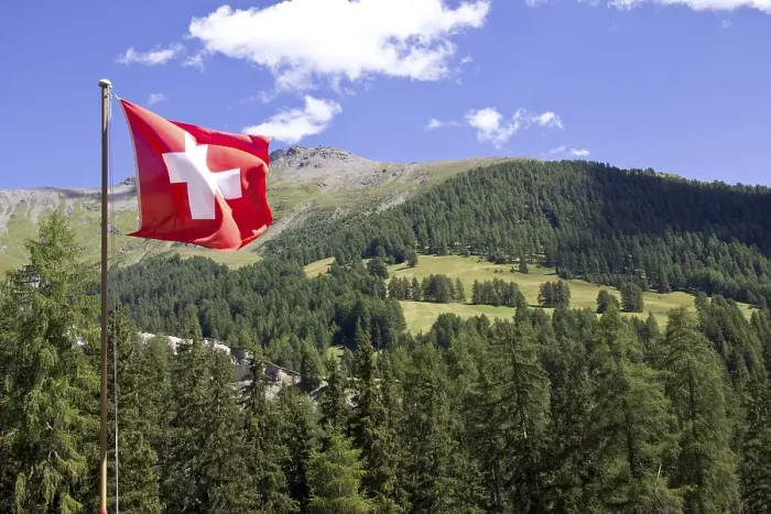 Framed Print : Mountain landscape with a Swiss national flag