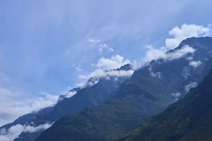 Framed Print : Mountain peak in the foreground with white clouds in the sky Framed Print : Mountain peak in the foreground with white clouds in the sky