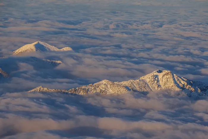 Framed Print : Mountain peak above high fog, evening light