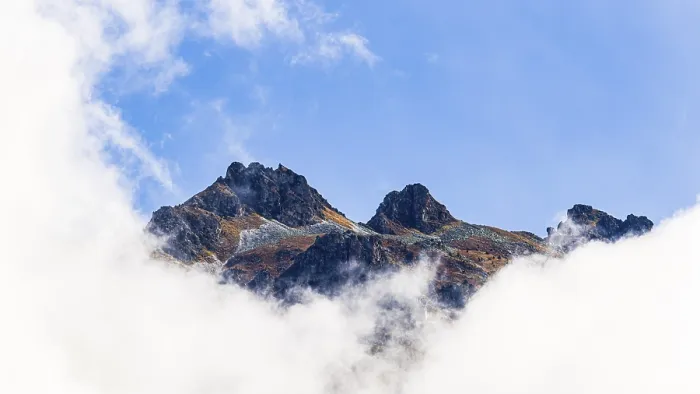 Framed Print : Mountain peaks rising out of fog
