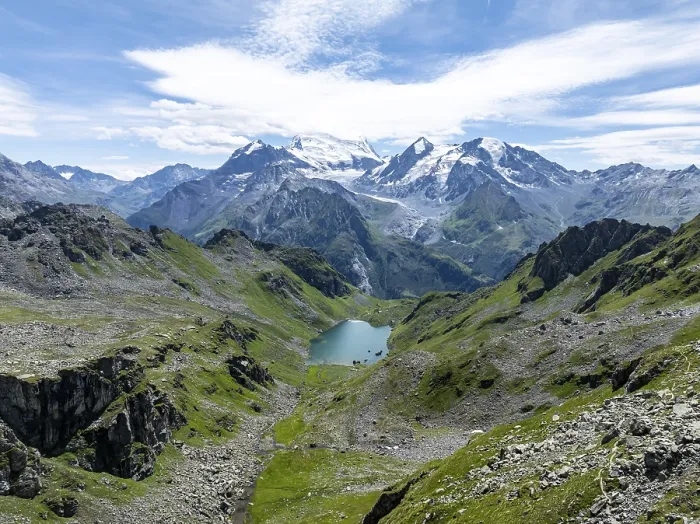 Framed Print : Mountain stream and mountain lake Lac de Louvie with glaciated summit of the Grand Combin