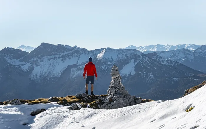 Framed Print : Mountaineer next to a cairn, in front of snowy mountains of the Rofan