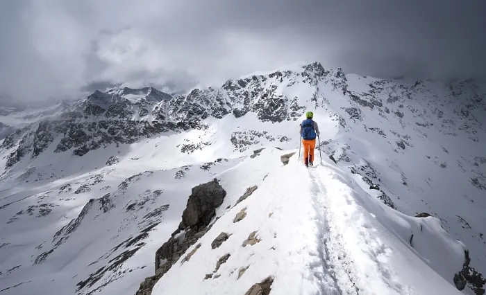Framed Print : Mountaineer descending the narrow ridge of Piz Laviner