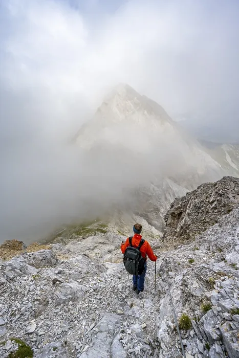 Framed Print : Mountaineer descending on a rocky mountain path