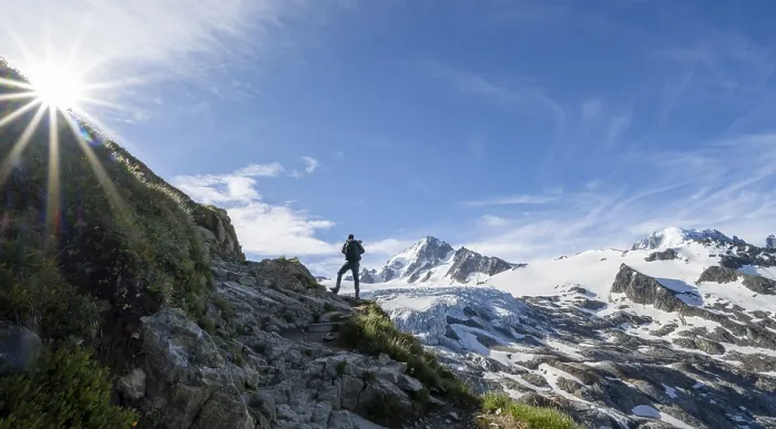 Framed Print : Mountaineer in front of high alpine mountain landscape with sun star Framed Print : Mountaineer in front of high alpine mountain landscape with sun star