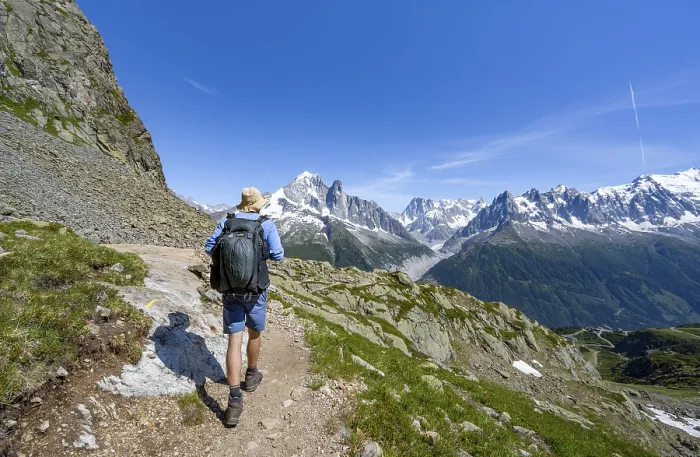 Framed Print : Mountaineer on a hiking trail in front of a mountain landscape