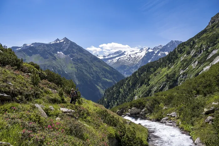 Framed Print : Mountaineer on a hiking trail by a stream