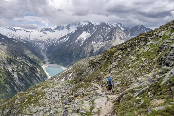 Framed Print : Mountaineer on hiking trail, view of Schlegeisspeicher