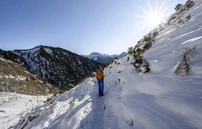 Framed Print : Mountaineer on hiking trail in winter with snow