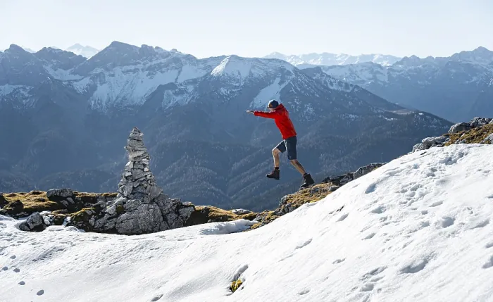 Framed Print : Mountaineer jumping, next to a cairn Framed Print : Mountaineer jumping, next to a cairn