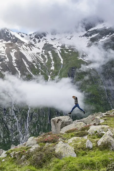 Framed Print : Mountaineer jumping from one rock to the next