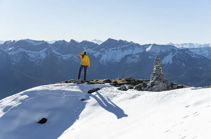 Framed Print : Mountaineer looks over snow-covered mountains