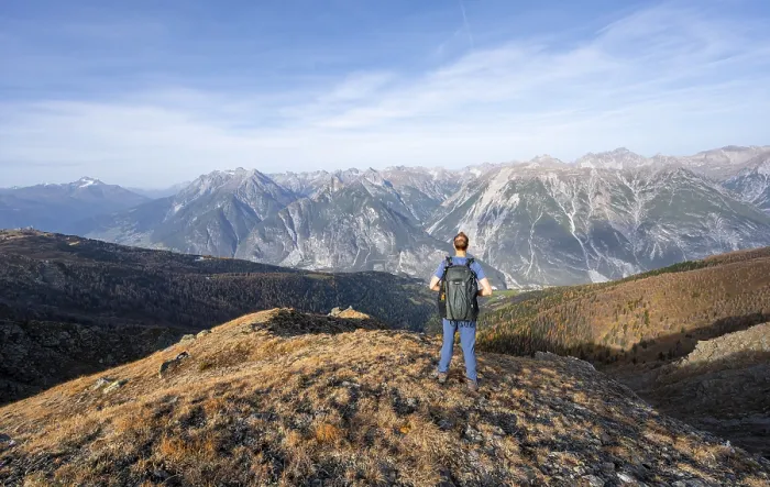 Framed Print : Mountaineer in front of a mountain panorama on a mountain ridge