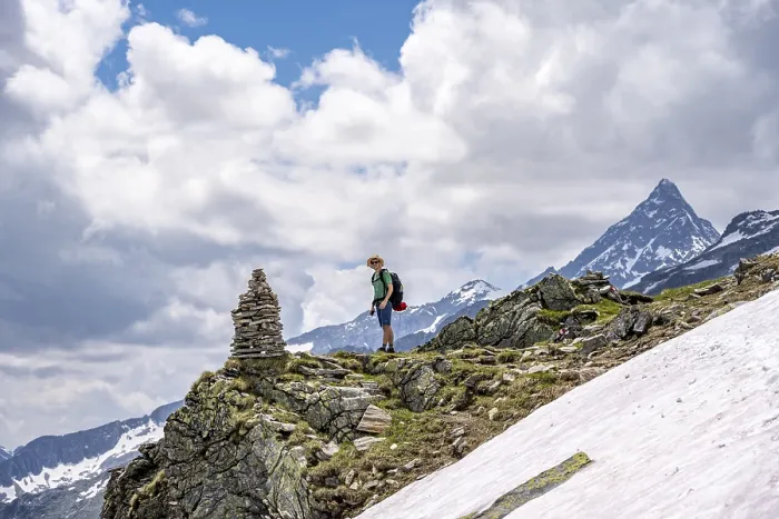Framed Print : Mountaineer on a rocky hiking trail with cairns
