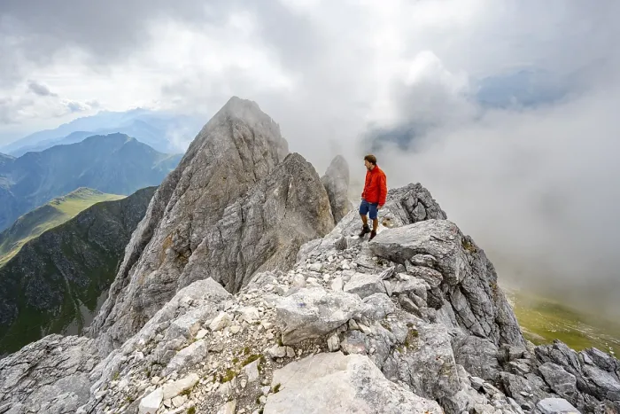 Framed Print : Mountaineer on a rocky narrow summit ridge