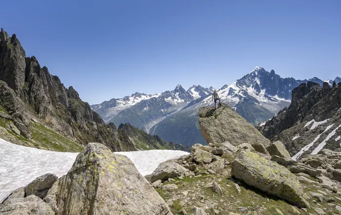 Framed Print : Mountaineer standing on a rock