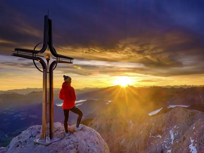 Framed Print : Mountaineer at the summit cross Hohe Goell at sunrise