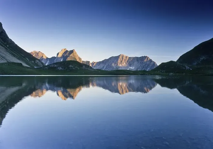 Framed Print : Mountains reflected in Lake Seewiessee near Memminger Huette alpine hut