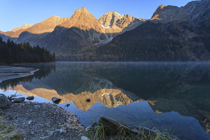 Framed Print : Mountains reflected in lake at sunrise