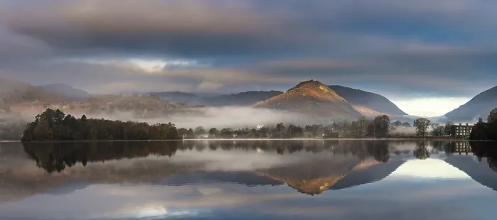Framed Print : Mountains reflected in water surface with fog