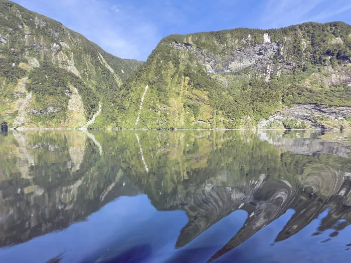 Framed Print : Mountains with reflections in the water against a blue sky in Doubtful Sound