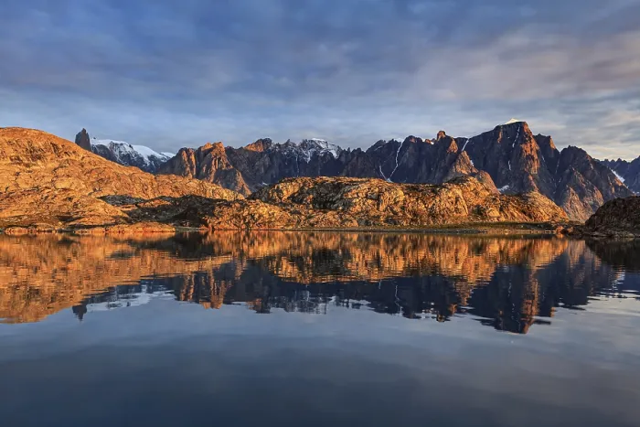 Framed Print : Mountains and rocks reflected in fjord