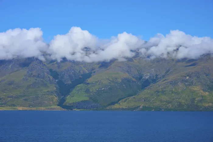 Framed Print : Mountains with a wreath of clouds over a blue lake under a clear sky