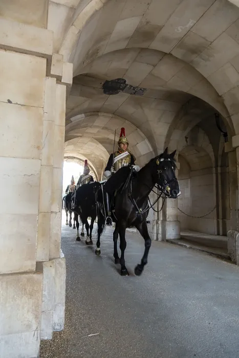 Framed Print : Mounted guards in black uniforms ride in formation beneath the stone arches during the daily Changing of the Guard Framed Print : Mounted guards in black uniforms ride in formation beneath the stone arches during the daily Changing of the Guard