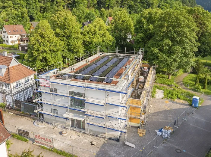 Framed Print : Multi-storey building with solar panels in a green environment