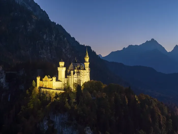 Framed Print : Mysterious view of Neuschwanstein Castle at dusk with mountains in the background