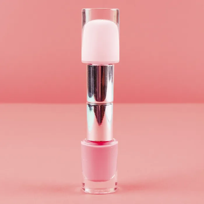 Framed Print : Two nail polish bottles against coral diagonal backdrop