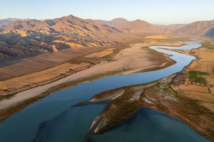 Framed Print : Naryn River between mountains and fields