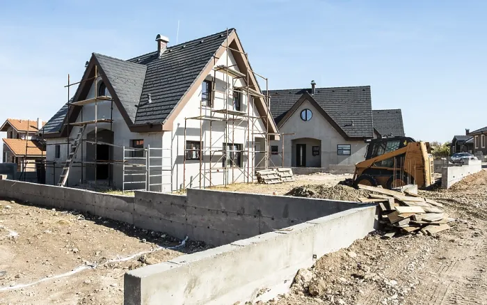 Framed Print : New build houses. Black roof, mountain
