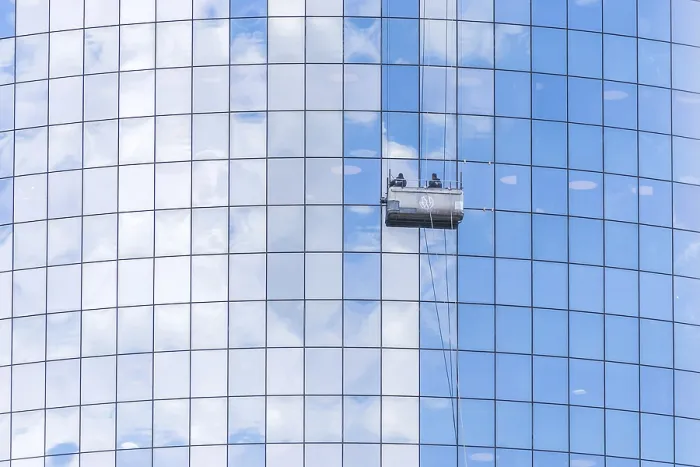 Framed Print : NEW YORK, USA - 16 MAY, 2019: Two cleaners washing the windows of modern skyscraper in New York Framed Print : NEW YORK, USA - 16 MAY, 2019: Two cleaners washing the windows of modern skyscraper in New York