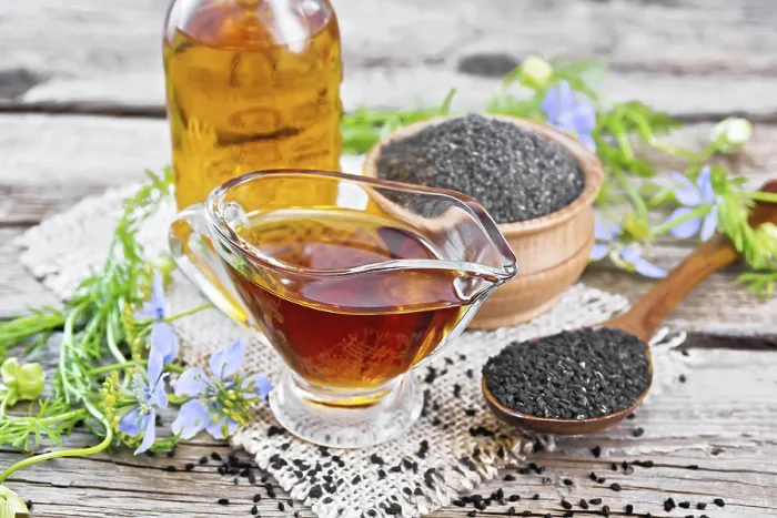 Framed Print : Nigella sativa oil in sauceboat and bottle
