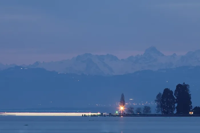 Framed Print : Night over a lake, with rays of light and mountains in the background