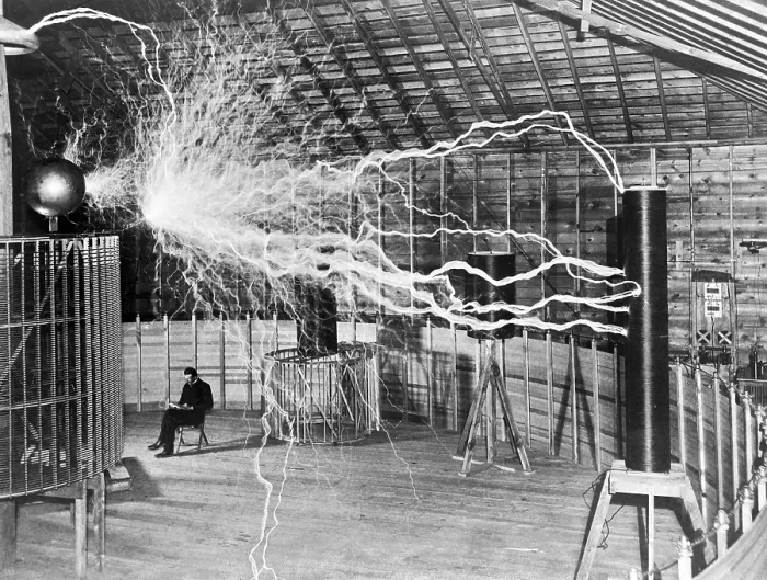 Framed Print : Nikola Tesla sits next to his amplifier transmitter