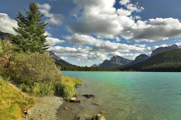 Framed Print : Northern lake surrounded by a wood and mountains in Canada