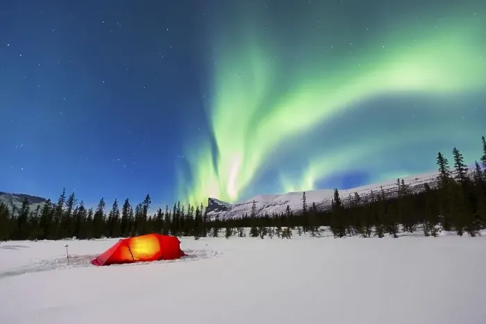 Framed Print : Northern Lights (Aurora borealis) above a red illuminated tent in winter
