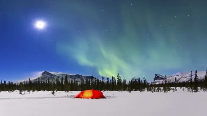 Framed Print : Northern Lights (Aurora borealis) above a red illuminated tent in winter