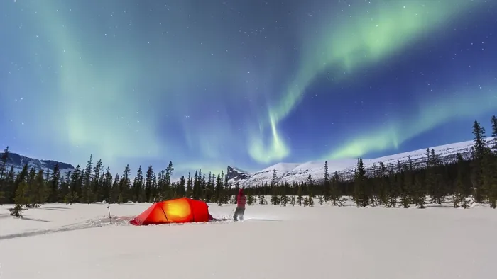 Framed Print : Northern Lights (Aurora borealis) above a red illuminated tent in winter