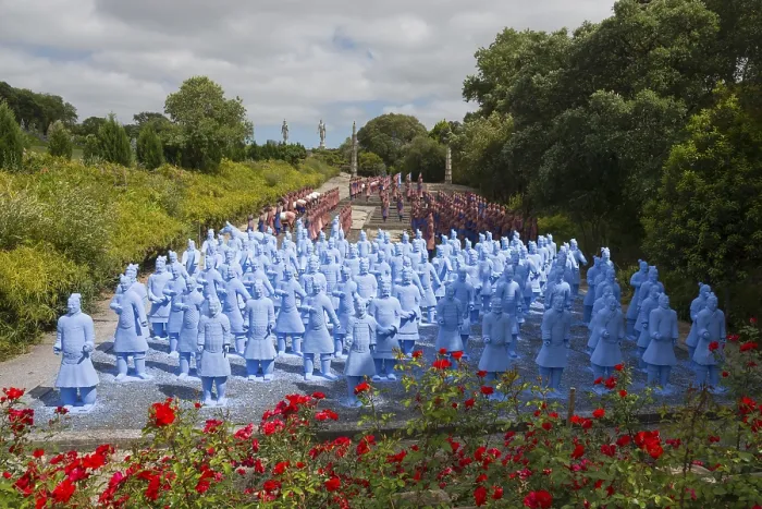 Framed Print : Numerous blue terracotta soldier statues stand on a path lined with flowers and trees Framed Print : Numerous blue terracotta soldier statues stand on a path lined with flowers and trees