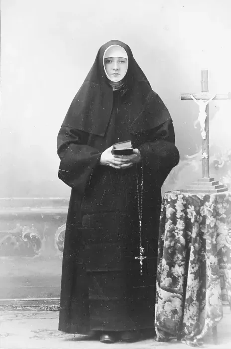 Framed Print : Nun with crucifix, rosary and prayer book
