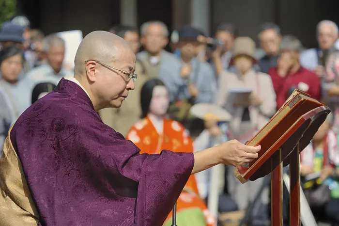 Framed Print : Nun wearing sutras for a Buddhist memorial service