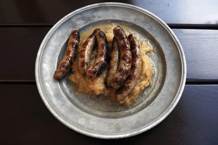 Framed Print : Six Nuremberg sausages with sauerkraut served on a pewter plate