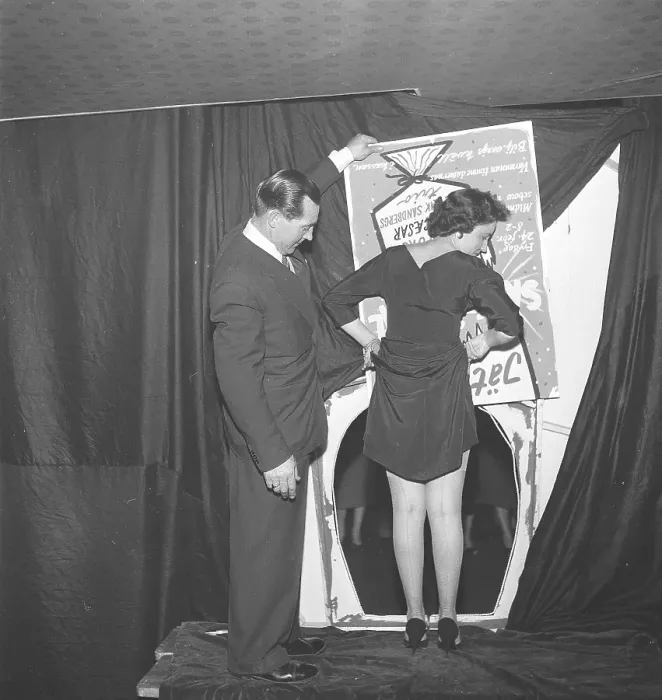 Framed Print : Odd beauty pageant in the 1950s. A young woman participates in a competition where the woman with the most beautiful legs will be crowned Framed Print : Odd beauty pageant in the 1950s. A young woman participates in a competition where the woman with the most beautiful legs will be crowned
