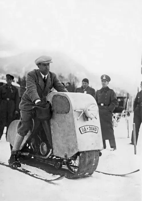 Framed Print : Odd winter vehicle. A man is sitting on his home made snow mobile Framed Print : Odd winter vehicle. A man is sitting on his home made snow mobile