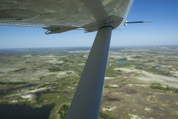 Framed Print : Okavango Delta aerial view with aeroplane wing