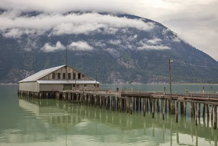 Framed Print : The old abandoned fish cannery on the wooden pier at Bella Coola