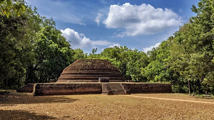 Framed Print : An old brick stupa surrounded by thick greenery and a cloudy sky Framed Print : An old brick stupa surrounded by thick greenery and a cloudy sky